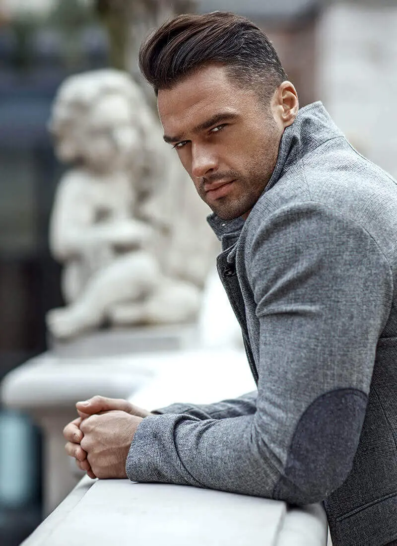 Man leaning against a marble railing