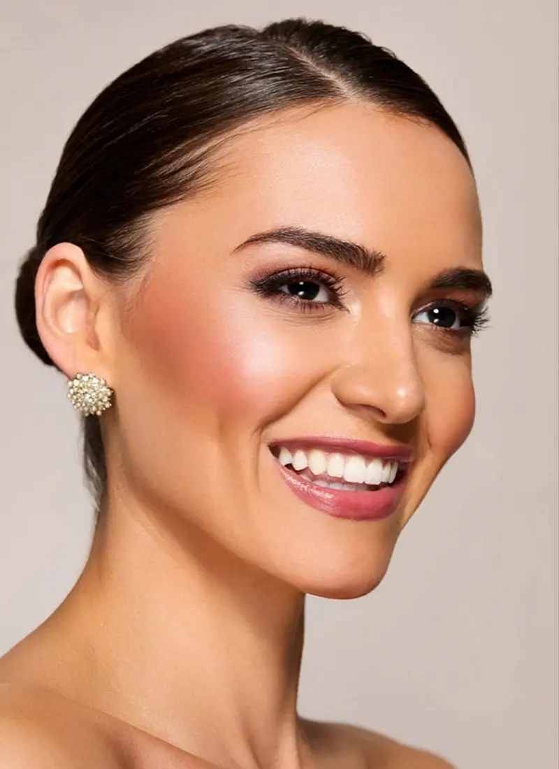 Profile of a woman with red cheeks smiling